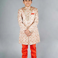 It is a peach-coloured heavy Jacquard Sherwani for the groom/bride's brother's wedding in the family. It consists of a Sherwani Coat with a matching Orange Churidar Pyjama.