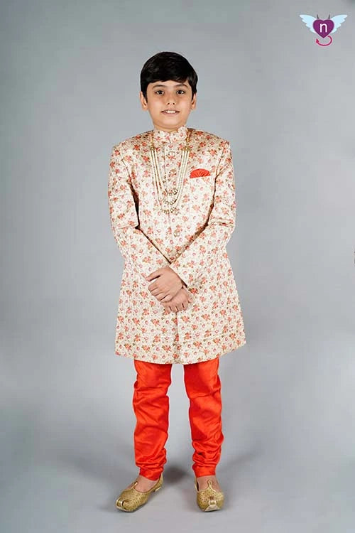 It is a peach-coloured heavy Jacquard Sherwani for the groom/bride's brother's wedding in the family. It consists of a Sherwani Coat with a matching Orange Churidar Pyjama.