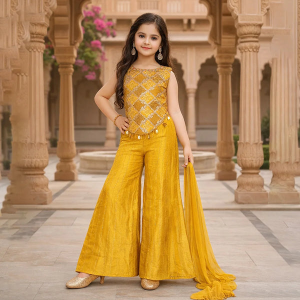 Young girl in a yellow traditional outfit standing in an architectural setting.