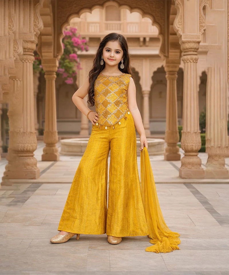 Young girl in a yellow traditional outfit standing in an architectural setting.