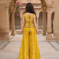 Woman in a yellow traditional outfit standing in an architectural setting