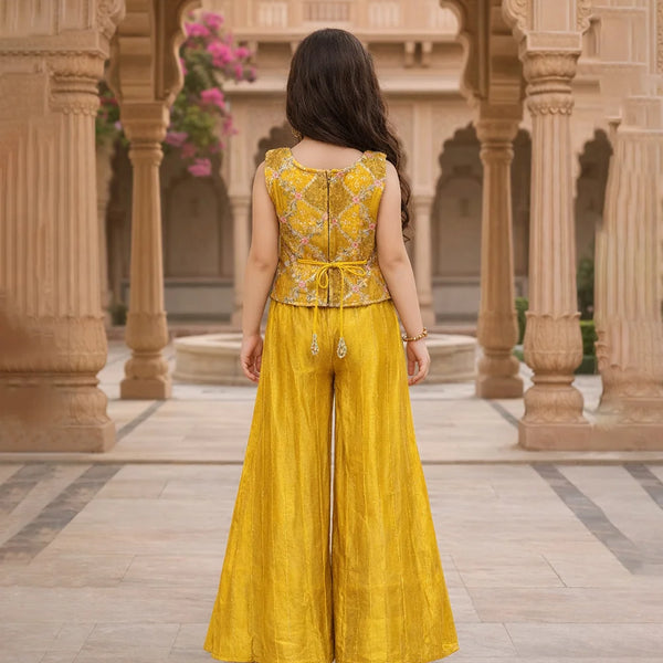Woman in a yellow traditional outfit standing in an architectural setting