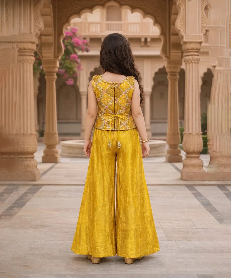 Woman in a yellow traditional outfit standing in an architectural setting