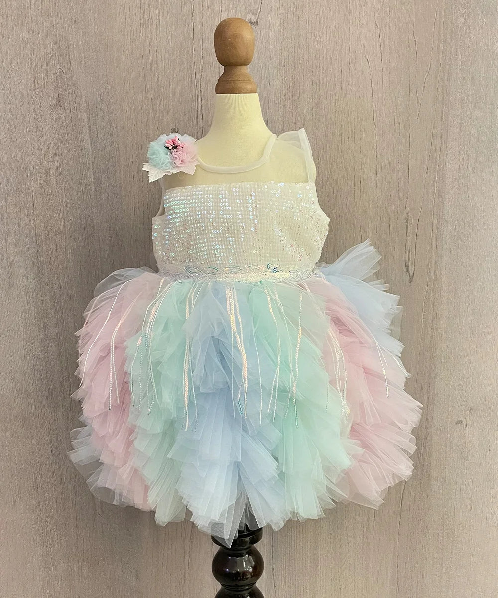 Multi Colored frock that comes with a back zip closure. It features sequin fringes and a cute floral detailing. Moreover, it comes with the fabric belt to be tied at the back.