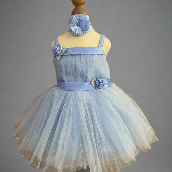 It is a sky blue shimmer frock with a back zip closure and comes with matching shoes and a hairband. It features cute flowers and ribbon detailing and an attached fabric belt to be tied at the back.
