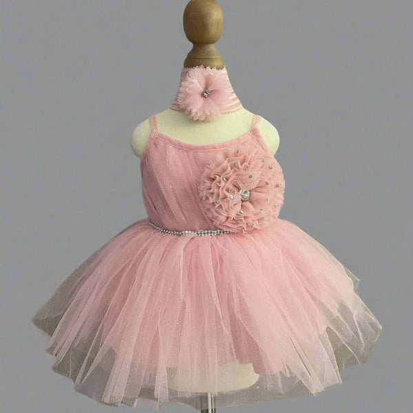  It’s a stylish peach Colored frock that comes with a back zip closure. It is paired up with matching shoes and hair band.