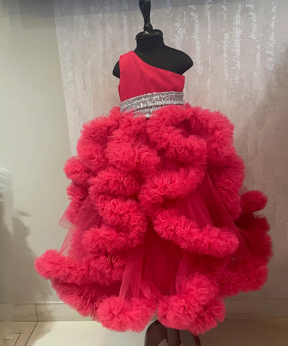It’s a fancy pink ruffle gown that comes with a side zip closure and is a perfect children birthday dress. It features pleated and sequin fabric detailing that uplifts the entire look.