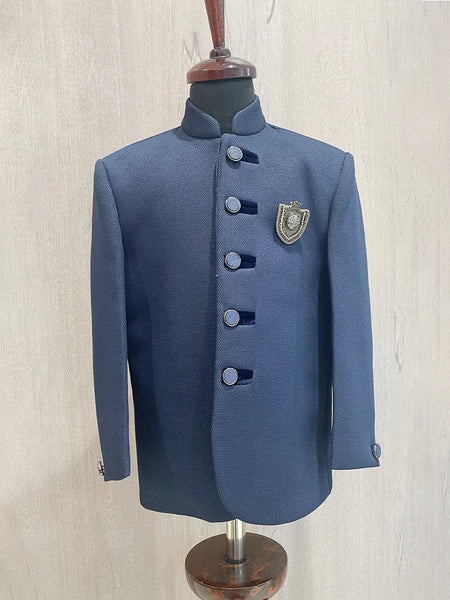  It’s a navy blue Colored boys wedding wear Jodhpuri coat that comes with an elegant broach.