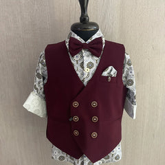 This wedding dress for small boy consists of a maroon Colored waistcoat, matching pants and a self-printed white Coloured shirt. It features a matching bow, a cute broach and a printed pocket square.