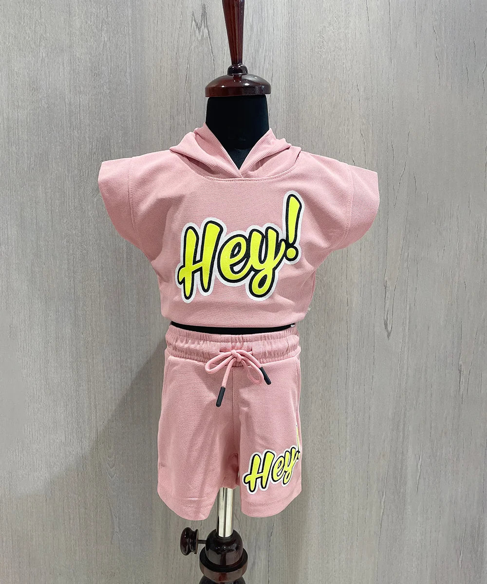 It Consists of a onion pink Colored hoodie top and shorts for girls. There is an embossed inscription on top and shorts both, moreover bottom comes with tie strings.