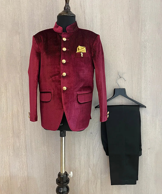 This Maroon party dress for boys consists of a Jodhpuri coat and matching black pants. It features a cute broach and golden-colored pocket square that adds grace to the look.