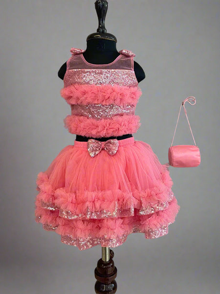  This  pink dress consists of a crop top that comes with a back hook closure and a layered skirt. It is paired up with a matching handbag. It features bow detailing on the shoulder and on the waist. Moreover, there are frill detailings on the dress that elevates the whole look.
