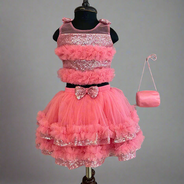  This  pink dress consists of a crop top that comes with a back hook closure and a layered skirt. It is paired up with a matching handbag. It features bow detailing on the shoulder and on the waist. Moreover, there are frill detailings on the dress that elevates the whole look.