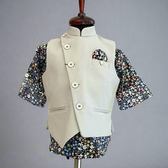 This boys party clothes set consists of a cream coloured waistcoat, matching pants and a self-printed blue Coloured shirt. It features a cute broach and a printed pocket square that uplifts the entire look.