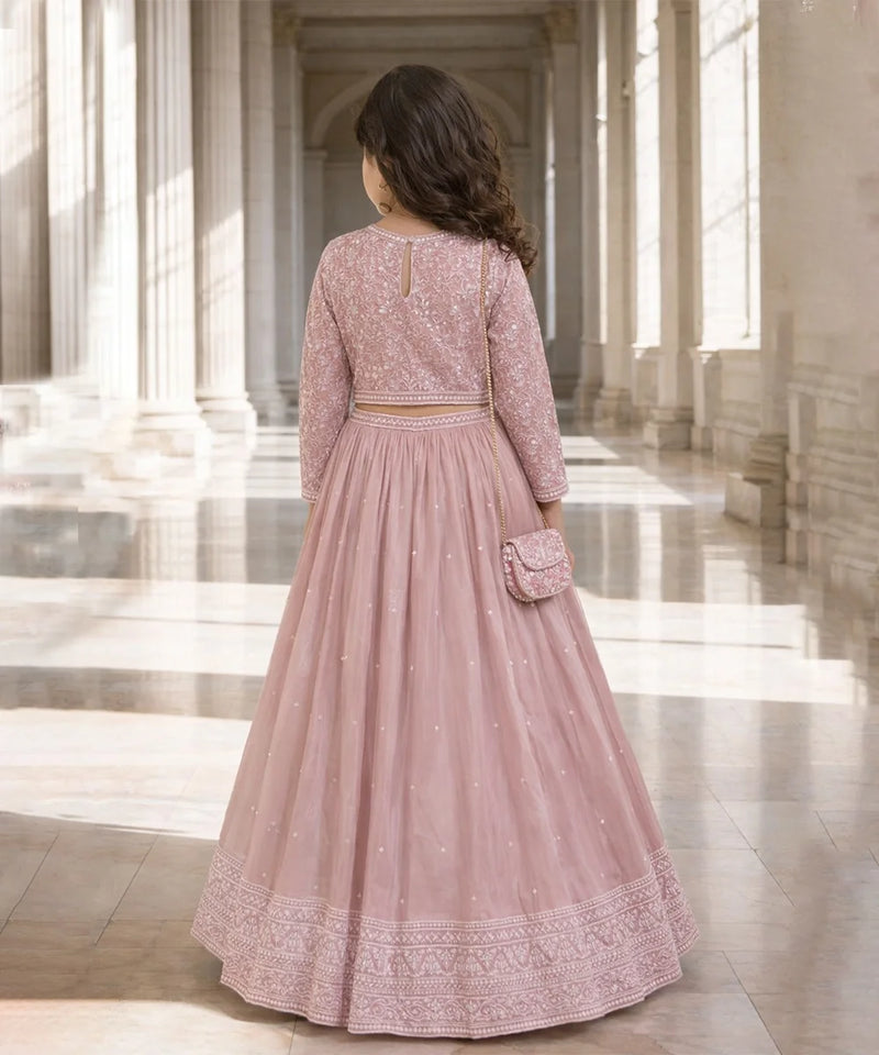 Woman in a pink traditional outfit standing in a classical architectural setting