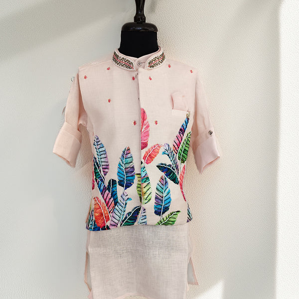 Light pink kurta with colorful leaf pattern on a mannequin against a white background