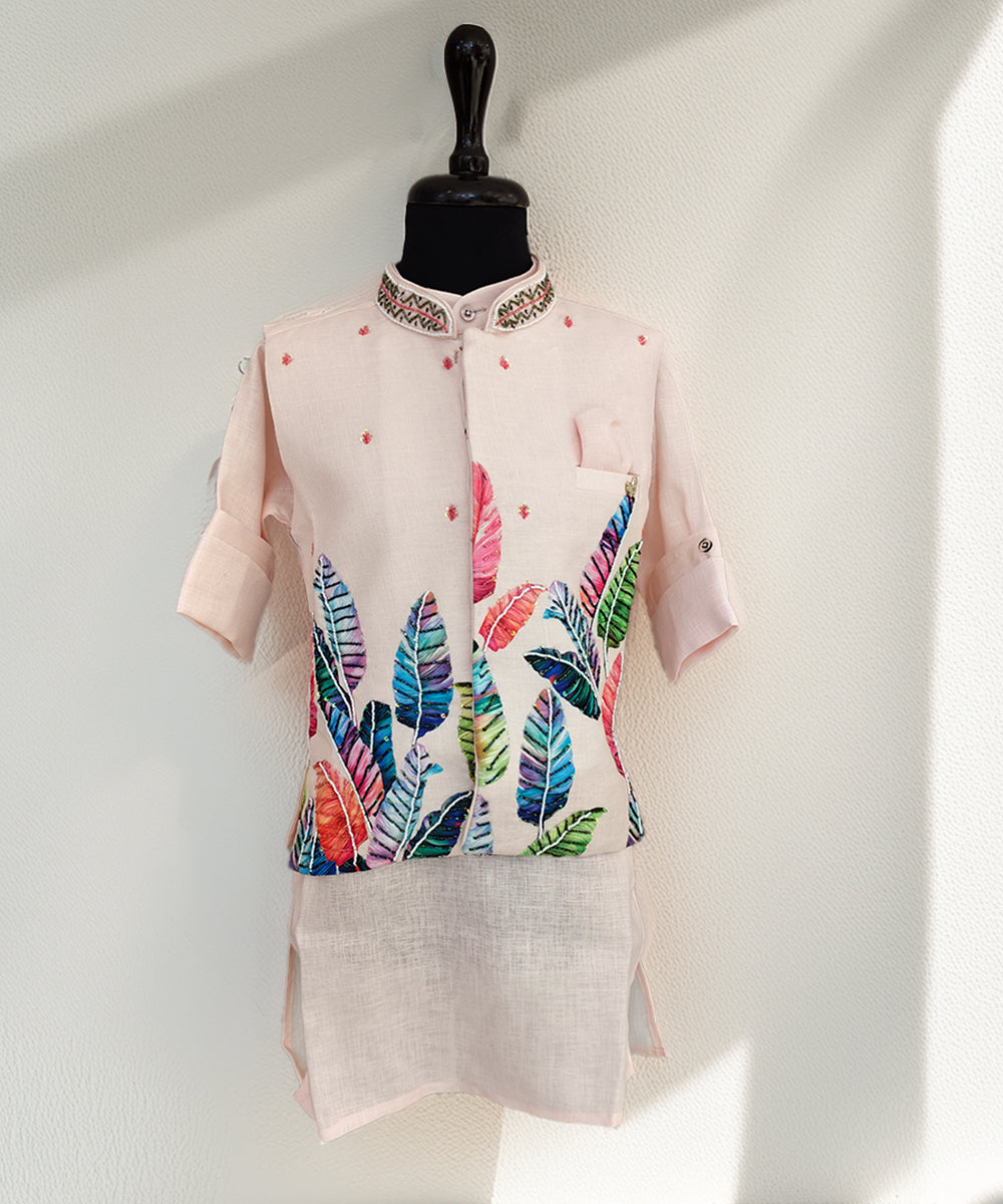 Light pink kurta with colorful leaf pattern on a mannequin against a white background