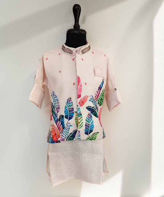 Light pink kurta with colorful leaf pattern on a mannequin against a white background