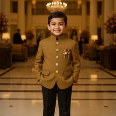 Young boy in formal attire standing in a luxurious interior setting with chandeliers and decor.