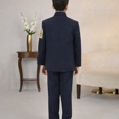 Person wearing a navy blue uniform with gold accents in an indoor setting.