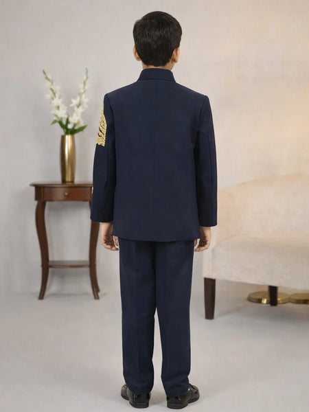 Person wearing a navy blue uniform with gold accents in an indoor setting.