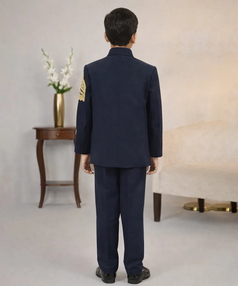 Person wearing a navy blue uniform with gold accents in an indoor setting.