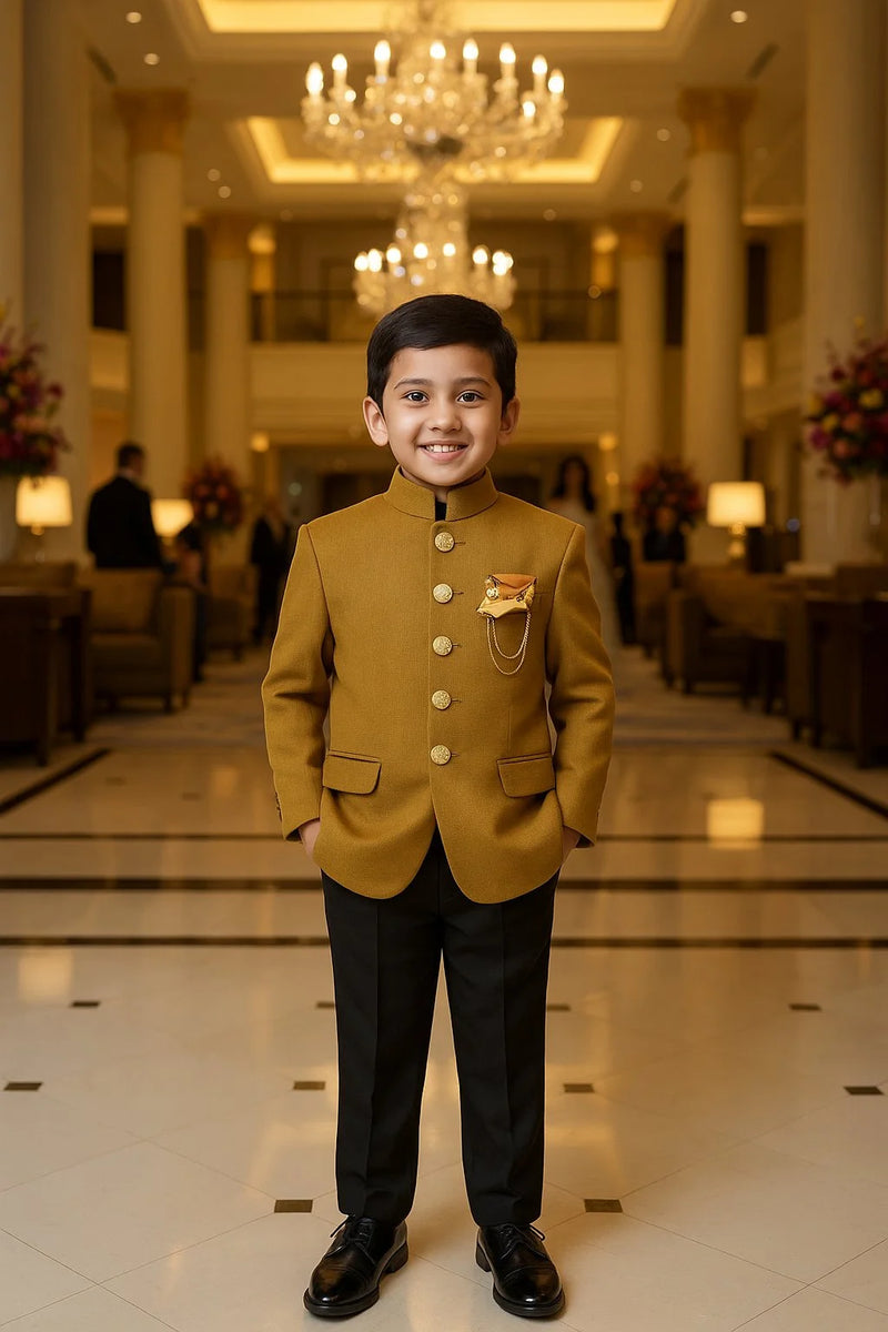 Young boy in a formal outfit standing in an elegant hallway with chandeliers and floral arrangements.