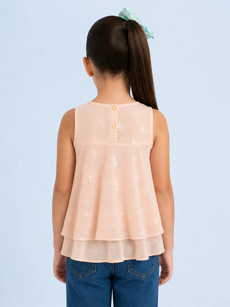Back view of a person wearing a peach layered top and blue jeans on a light blue background