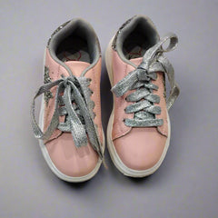 Close-up of trendy pink sneakers with silver glitter accents and padded collar, Jaipur