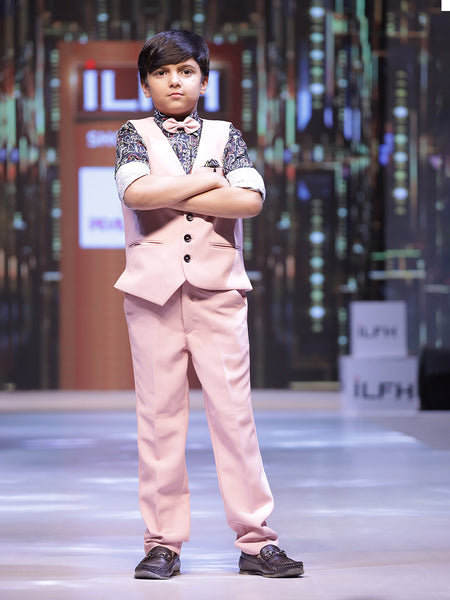 This boys party clothes set consists of a light pink Coloured waistcoat, matching pants and a self-printed shirt. It features a matching bow, a cute broach and a printed pocket square that uplifts the entire look.