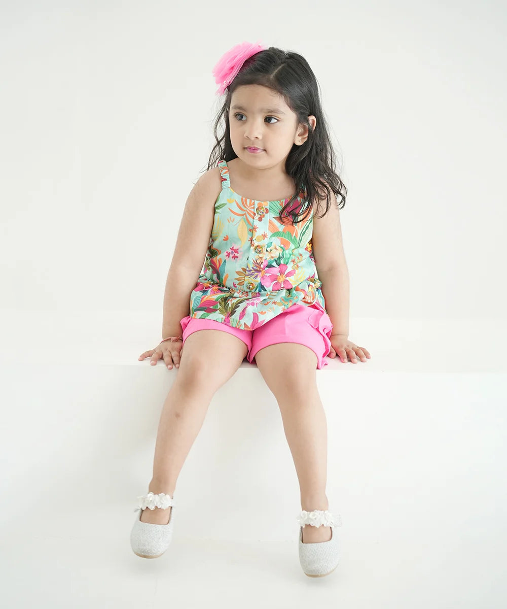 It Consists of a multi-coloured peplum top and&nbsp;pink coloured shorts for little girls. A Great option for a vacation look.