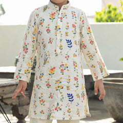 Child wearing a floral printed kurta with a white background
