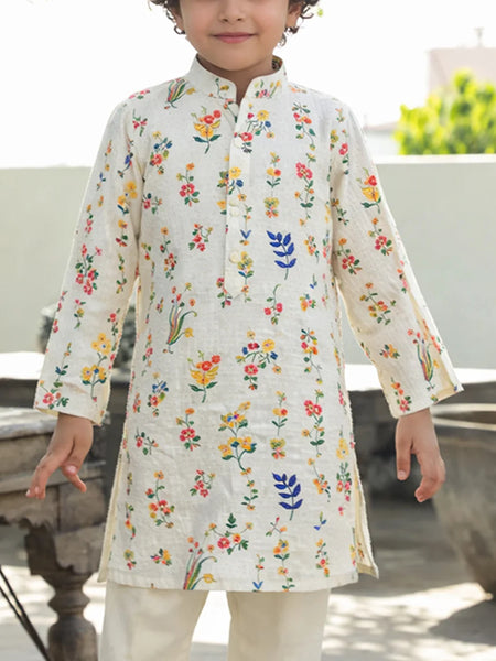 Child wearing a floral printed kurta with a white background