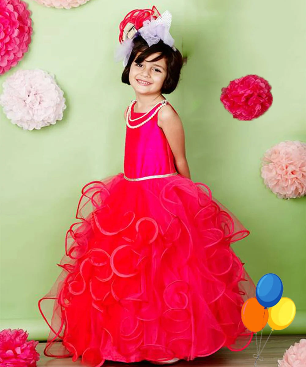  It’s a pink and red Colored party gown that comes with a back zip closure. It features lace and pearl detailing. Moreover, it also has a fabric belt to be tied at the back.