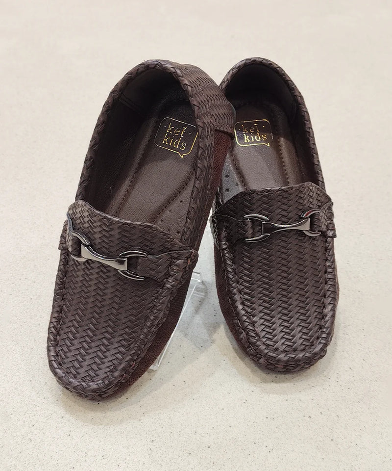 Pair of brown woven loafers on a light background