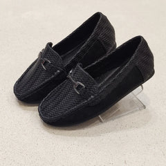 Pair of black loafers with woven texture on a light gray background