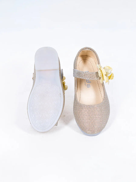 Close-up of girls' gold party flats with yellow flower detail and secure strap, Jaipur