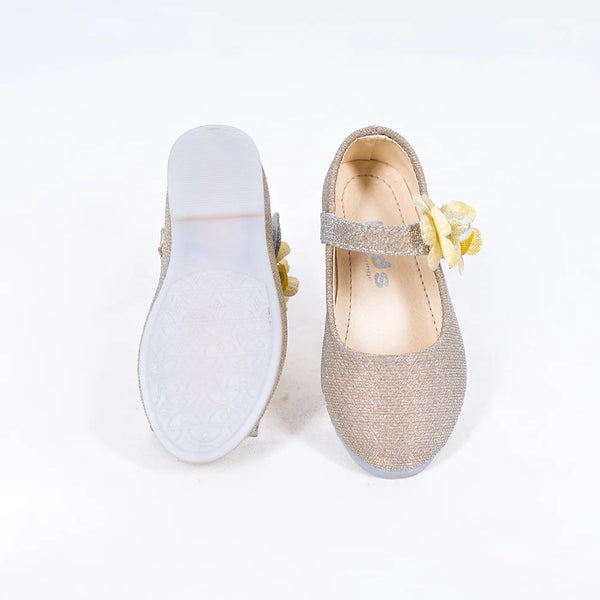 Close-up of girls' gold party flats with yellow flower detail and secure strap, Jaipur