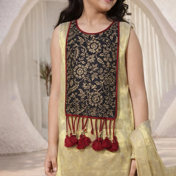Young girl wearing a traditional outfit with a black and gold top and yellow dupatta.