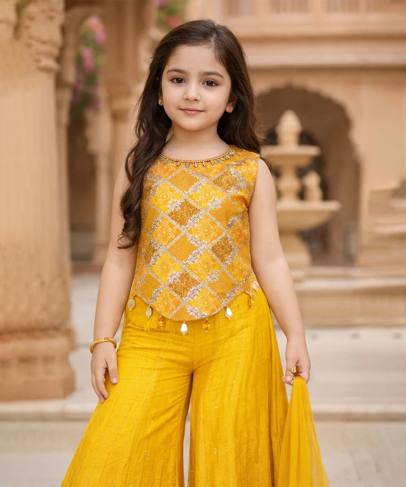 Young girl in a yellow traditional outfit standing in front of an architectural background