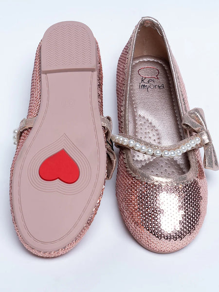 It's a pair of rose-gold Colored party-wear sandals for wedding parties. It features Patterned synthetic outsole, pearl and bow detailing on the belt.