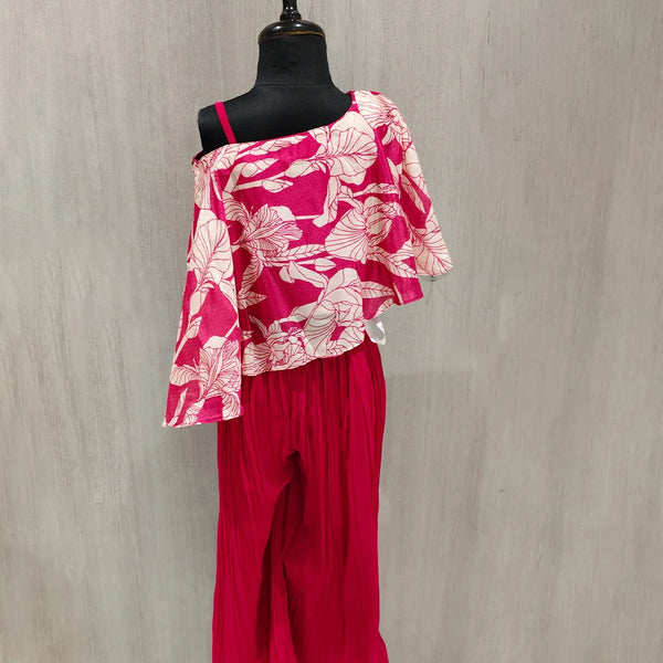 Mannequin wearing a pink floral top and pants against a gray background