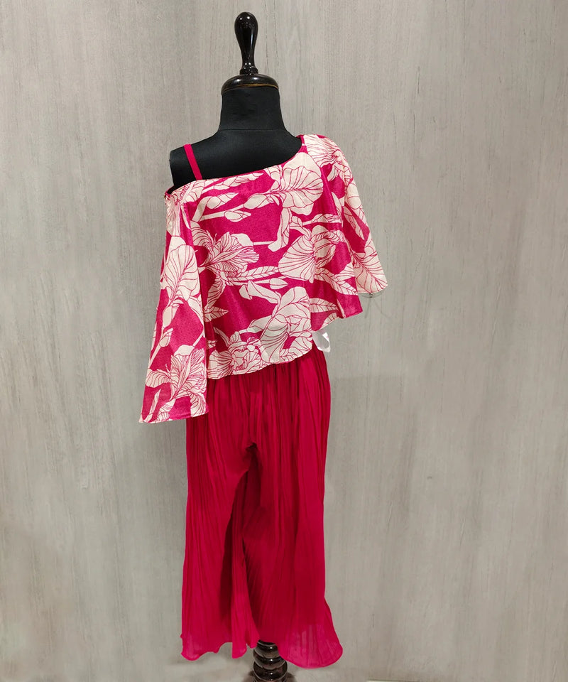 Mannequin wearing a pink floral top and pants against a gray background
