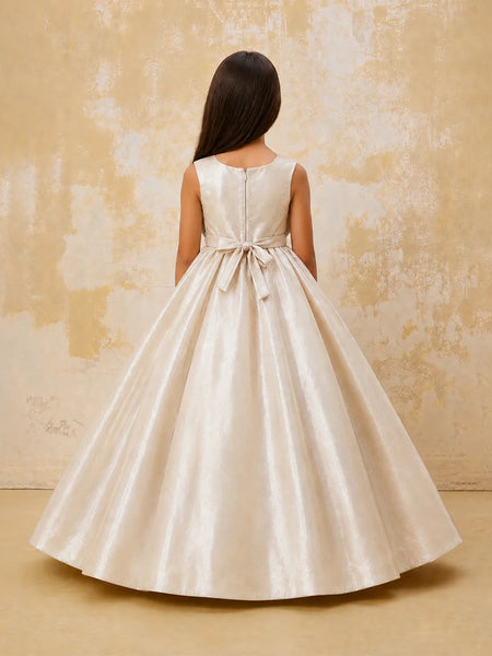 Woman wearing a white dress with a bow detail on a textured beige background