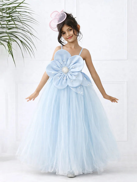 Young girl in a light blue floral dress with a large flower on a white background