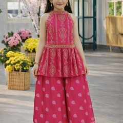 Young girl wearing a pink traditional outfit with floral decorations in the background