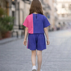 Person wearing a colorful outfit walking on a street