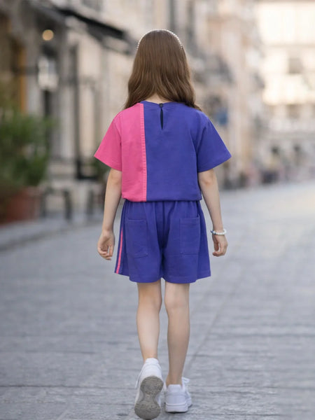 Person wearing a colorful outfit walking on a street