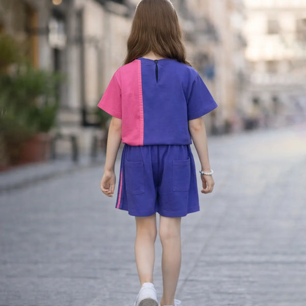 Person wearing a colorful outfit walking on a street