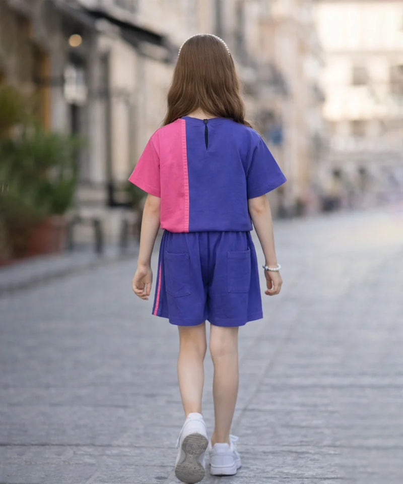 Person wearing a colorful outfit walking on a street